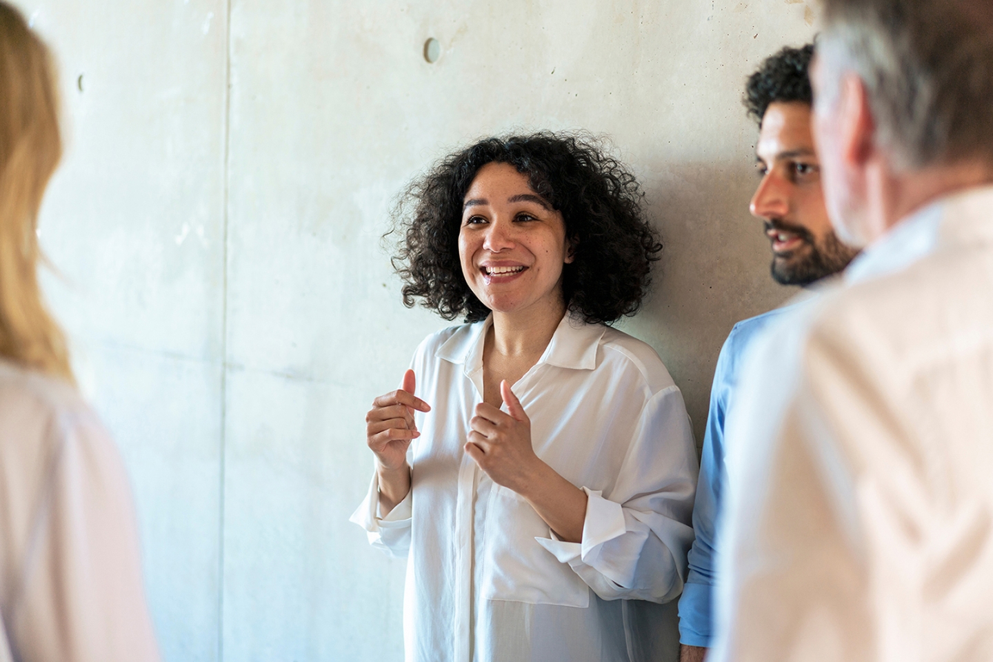 Happy businesswoman discussing with colleagues_high.jpg