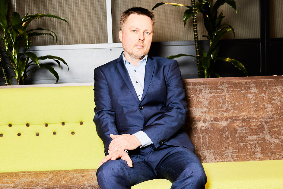 A focused half-body portrait of Bjarke Alling in formal attire, exuding authority and expertise.