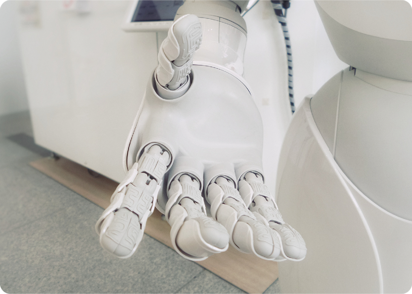Robotic hand with articulated fingers extended, shown in close-up.